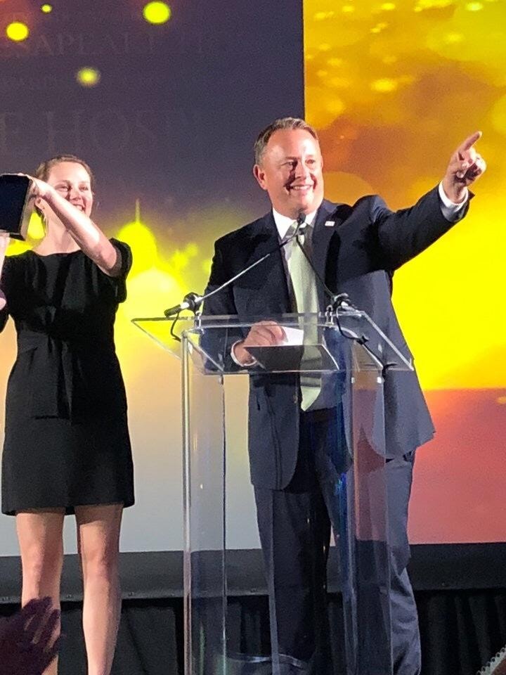W. Chris Green accepting an industry award on stage