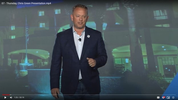 Chris Green presenting on stage at a hospitality conference